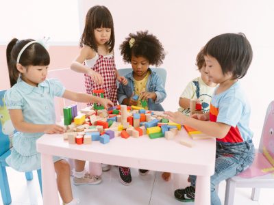 Group of diversity kids playing with colorful blocks on table in class at the kindergarten.Kindergarten international school, education concept.